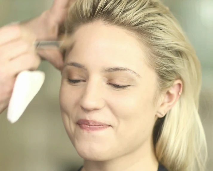 a lady is getting ready for her makeup and haircut