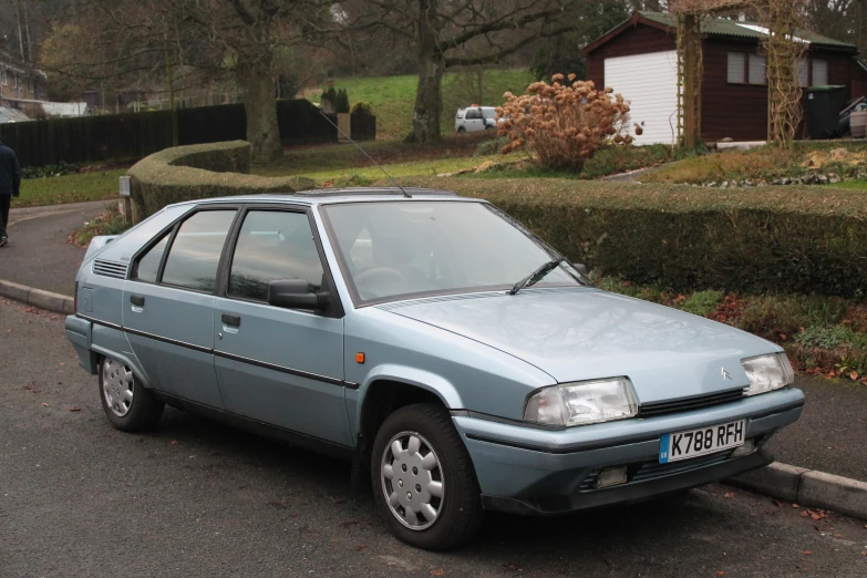 a blue car is parked on the side of the street