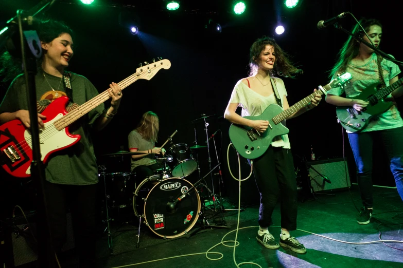 a group of people with guitars on a stage