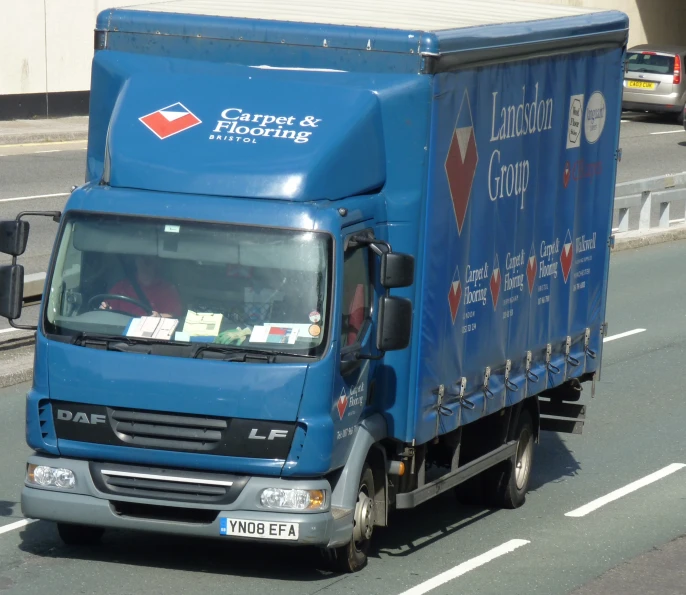 blue delivery truck with signs on the side