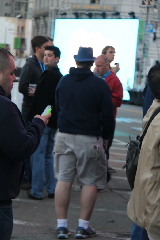 a group of people standing in a large city