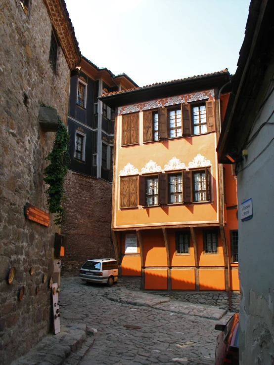 a building with lots of windows near a car