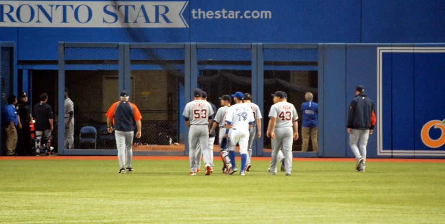 some baseball players in uniform standing together