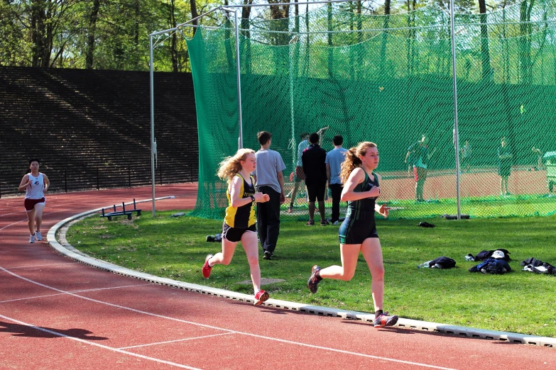 two women racing on a race track in a park