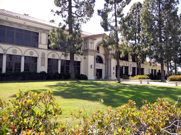 a white house with three stories and a porch