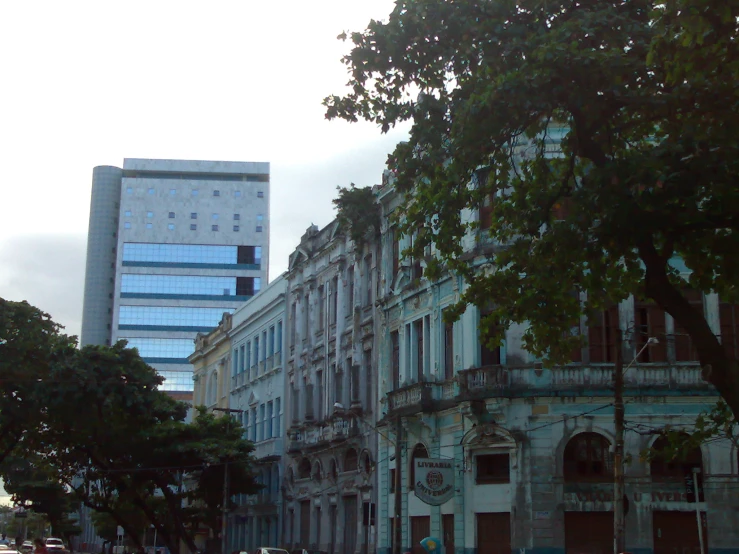 the buildings are located on a corner and have blue tinted glass