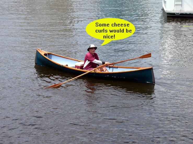 a man in a canoe with some cheese on his boat