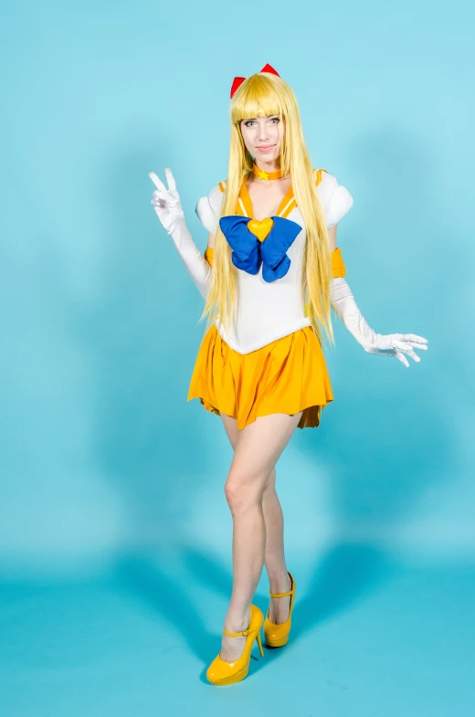 blonde haired girl in short yellow skirt with erfly costume