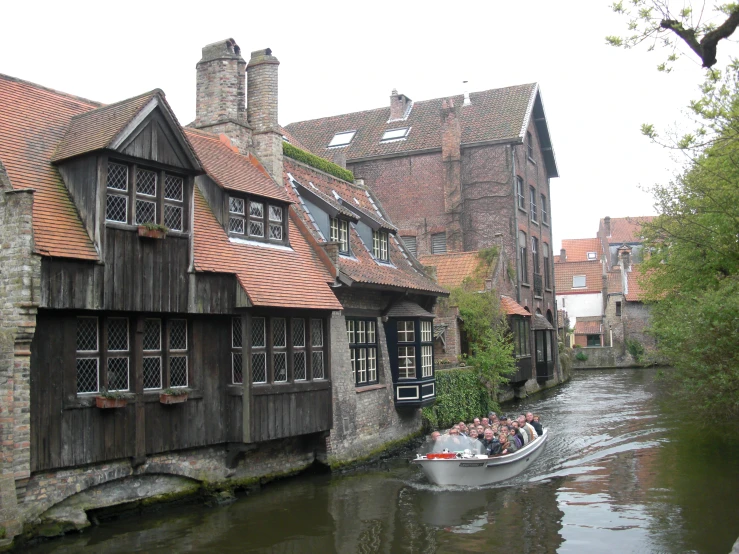 a boat travels down the river past a medieval village
