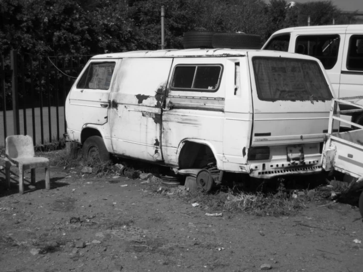 two vans that are parked in the dirt