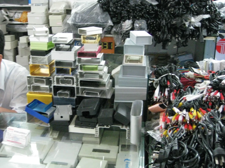 a store worker is working in front of many electrical components