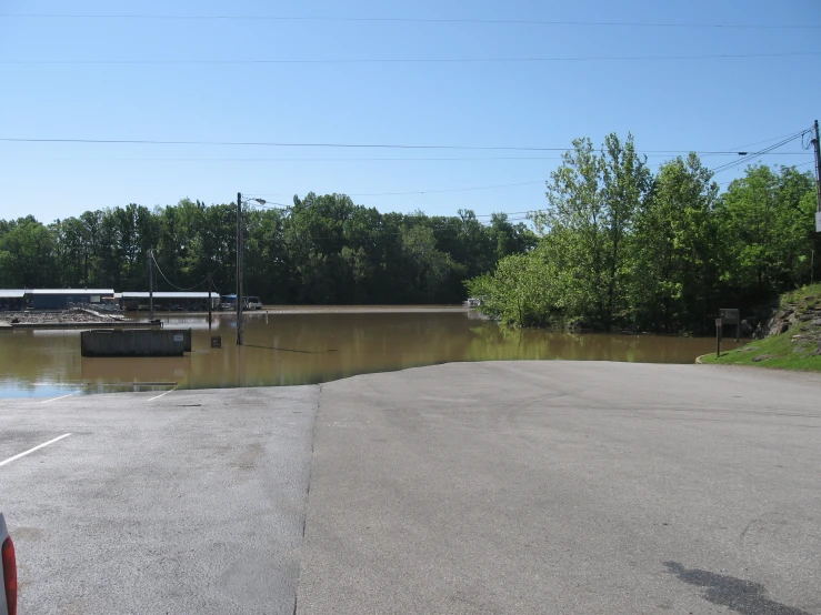 flood waters surrounding a street with a bus on a bridge