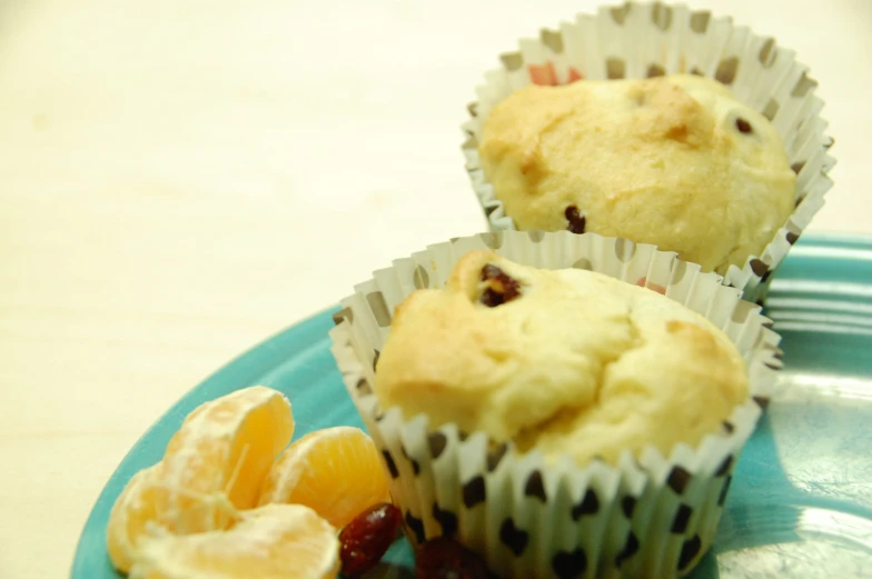 three muffins with chocolate chips on a blue plate