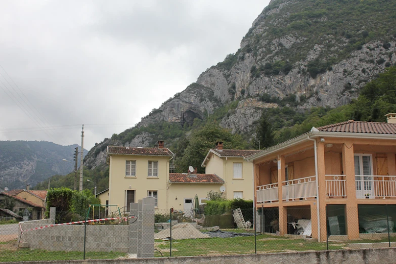 a very nice looking home with some tall mountains in the background