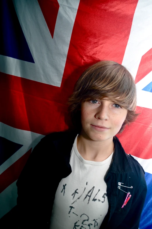 a man poses for a picture with a british flag background