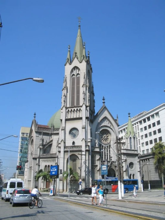 two people are standing outside a church with tall towers