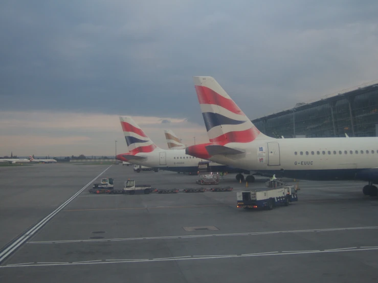 several airplanes parked in the parking lot of an airport