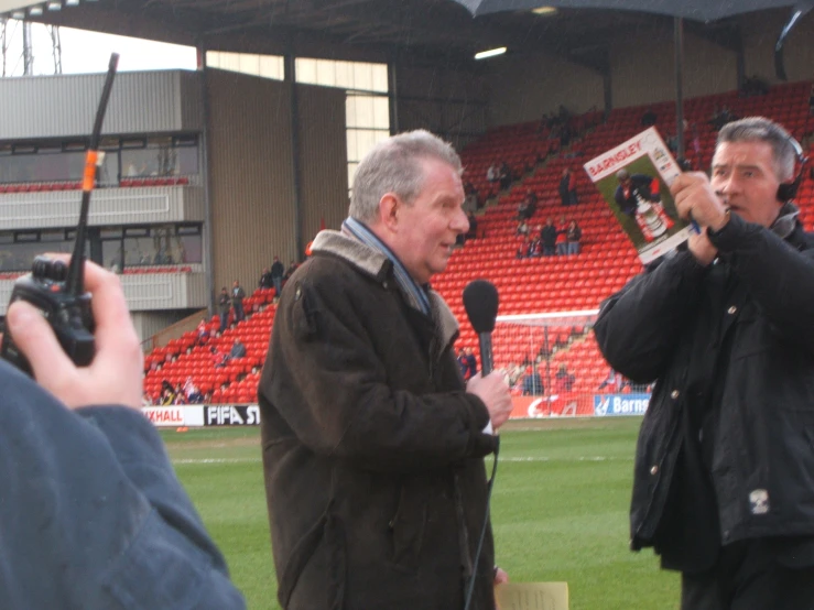 a man holding up an opened magazine