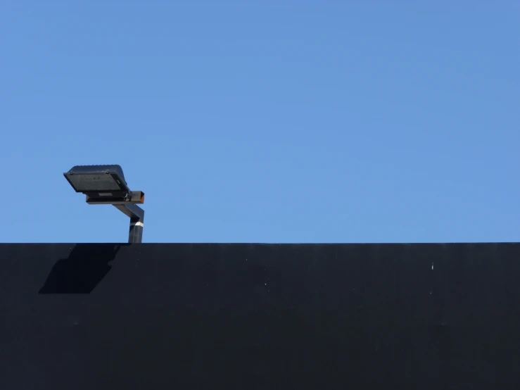 a security camera is on the top of a black structure