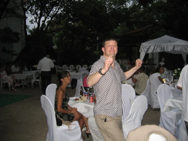 a man holding a wine bottle is posing for a picture