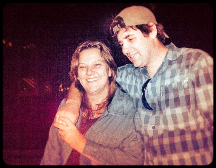 a smiling man and woman pose for a picture