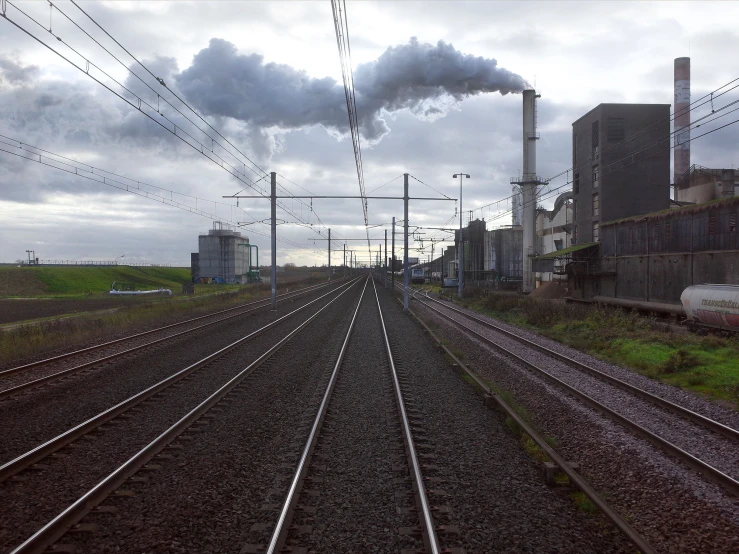 an industrial power plant emits steam from its stacks