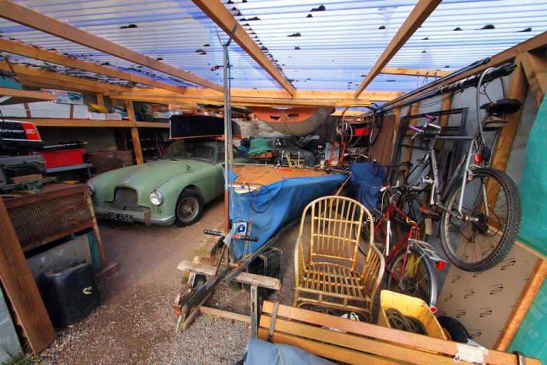 a very large and old - fashioned garage with a bicycle on the ceiling