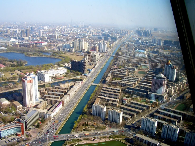 an aerial view shows a wide waterway and various buildings