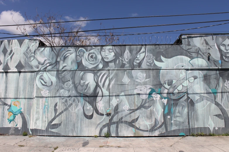 a large grey painted wall with some birds