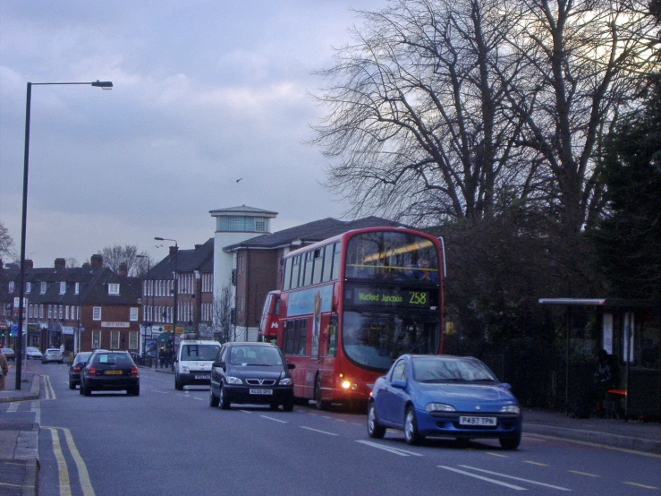 a double decker bus driving past a building on a street