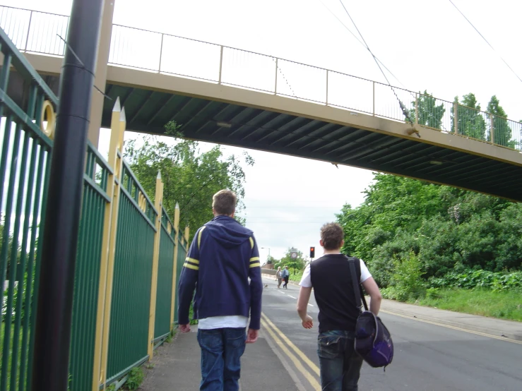 a couple of men walking down a street