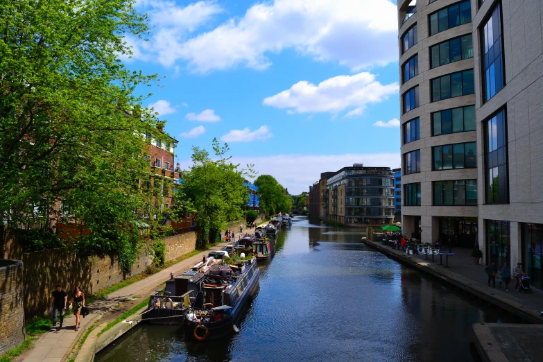 a line of boats parked along the side of a river