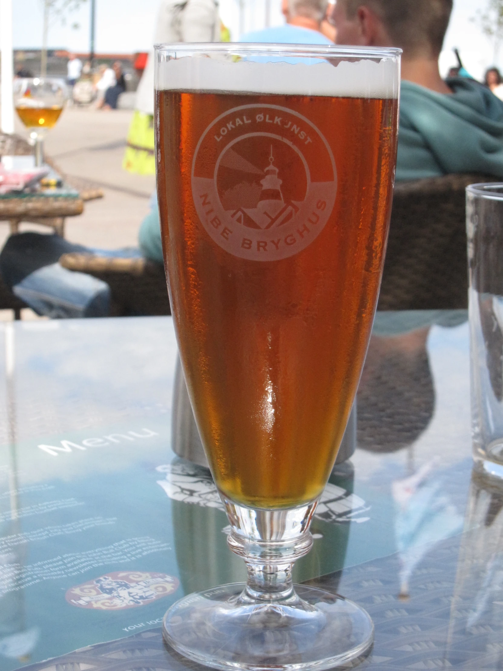 beer in a glass on a table outside