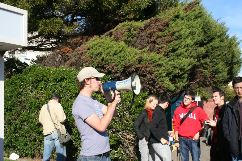 a man on the side walk with a speaker