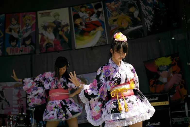 two women are dressed in fancy japanese costumes