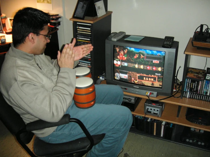 a man is sitting and watching the television