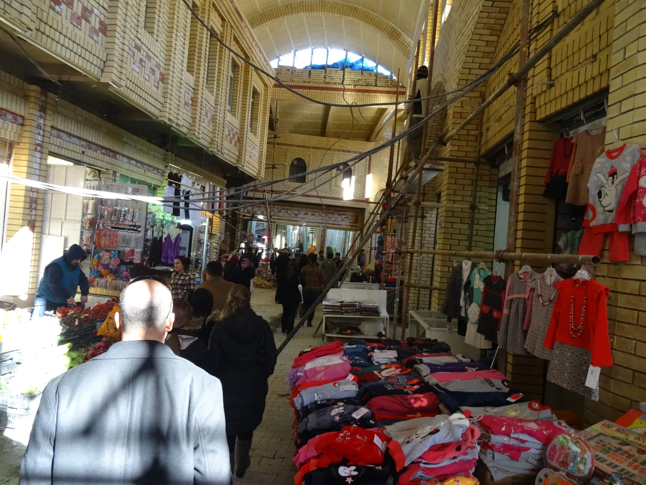 people inside a clothing store with many clothes on display