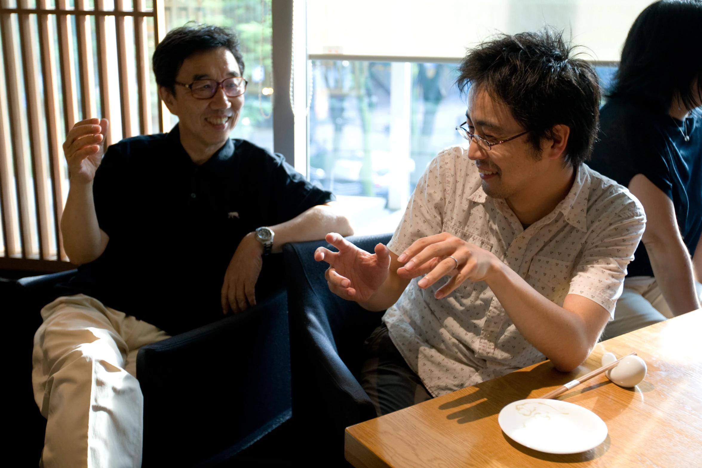 the men are discussing soing while seated at the table