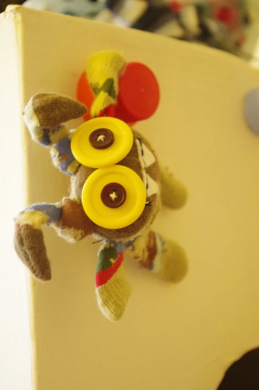 a stuffed animal with ons pinned to the side of it