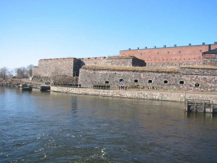 the old wall is near a large body of water