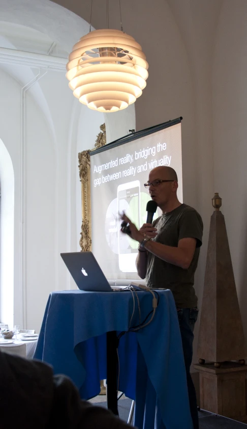 a man giving a presentation in front of an audience