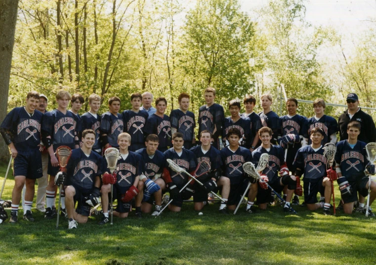 group of young lacrosse players posing in t - shirts for picture