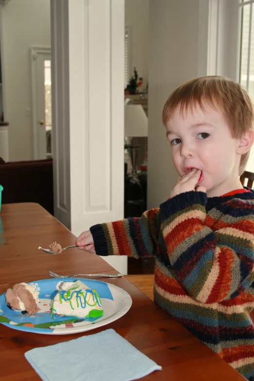 there is a  sitting at the table and eating