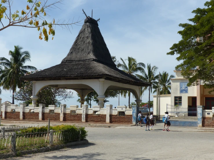 a white gazebo with three children playing with it