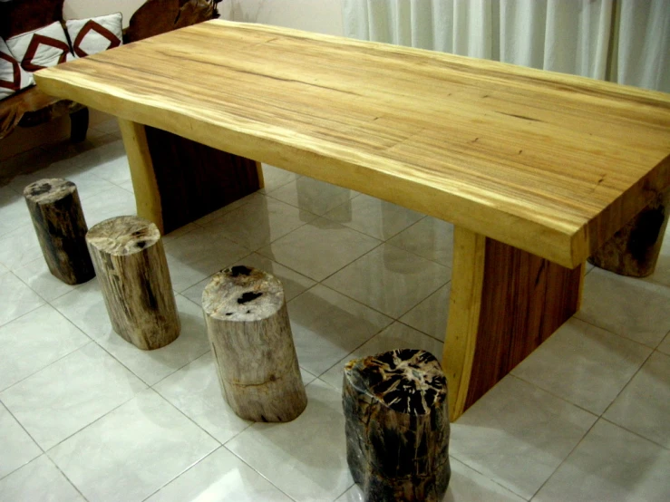 there are wood pieces around a table that is made from logs