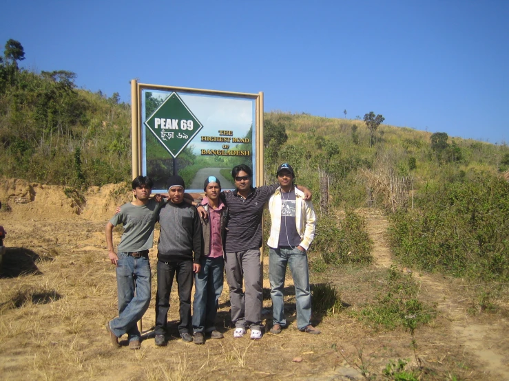 five men standing next to each other with their hands in the air