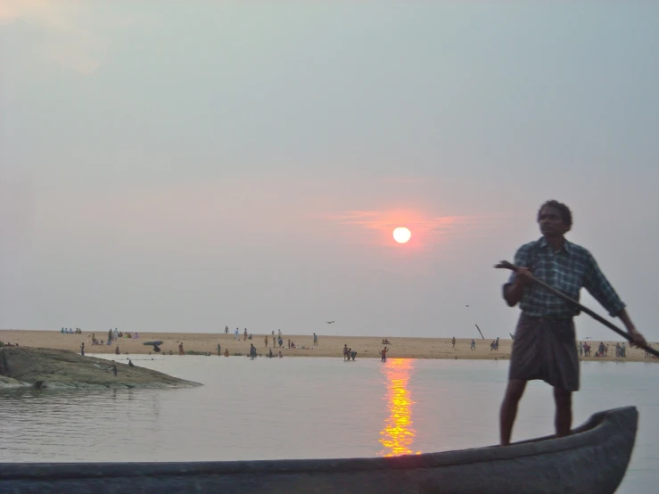 the man is standing on top of a boat