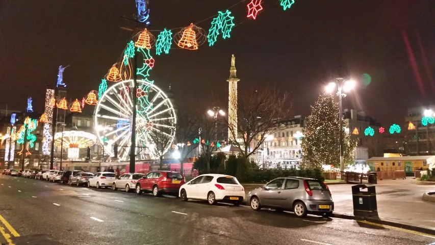 cars on a road with bright lights in the background