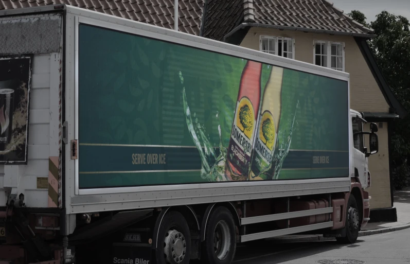 a semi truck with a beer advertit on the side