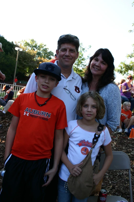 family standing together at an outdoor soccer game